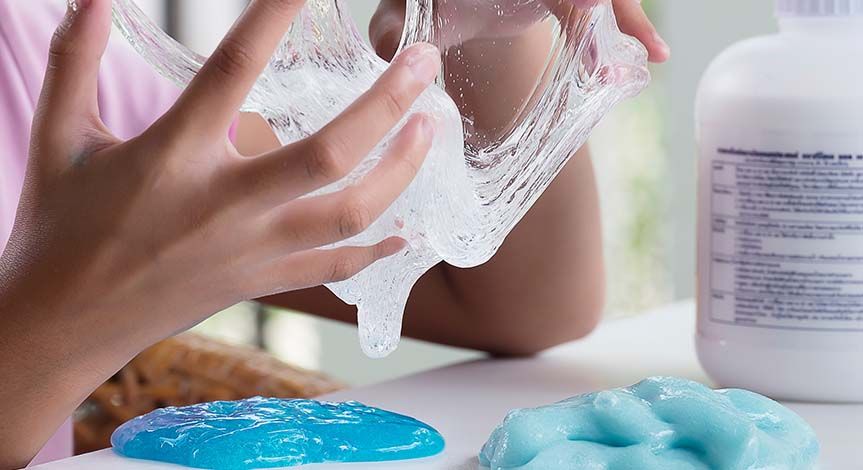 Female hands playing with clear slime