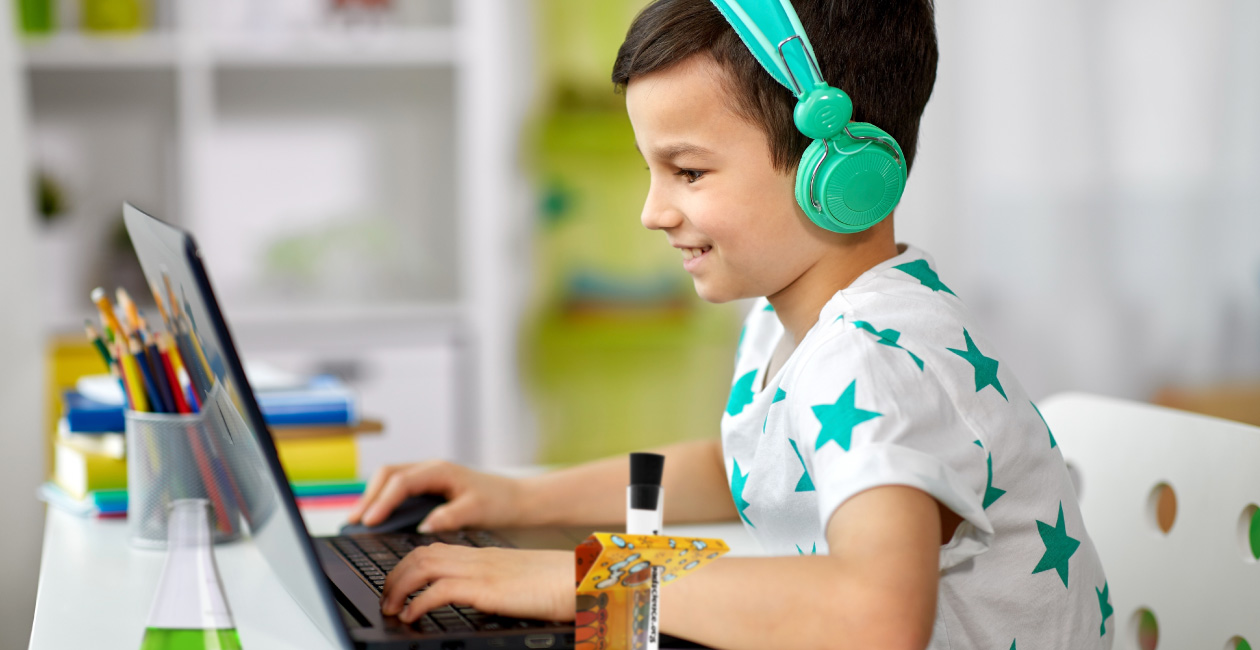 Boy performing a Mad Science Virtual class sitting in front of his computer